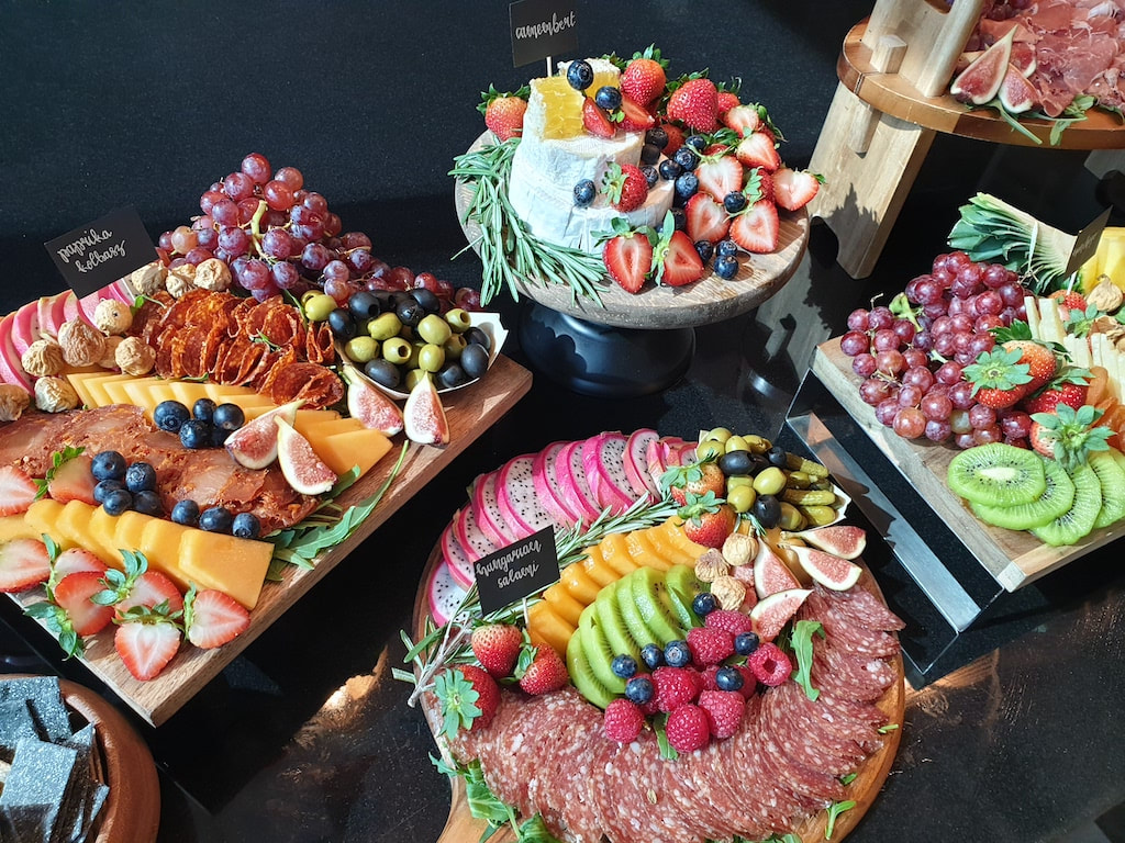 cheese board with cold meats and fruit, charcuterie, cheese tower with fruit
